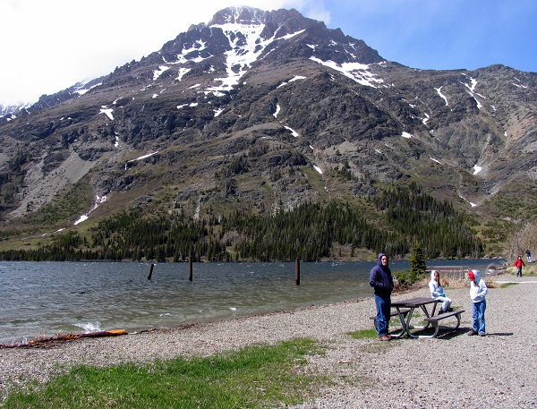 David with M and E on the beach of Two Medicine Lake in East Glacier