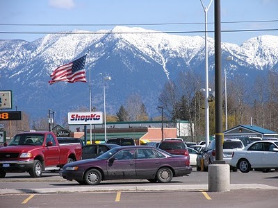 An American flag stands out against the view of the beautiful snow capped peaks of the Swan Range from the ShopKo parking lot.