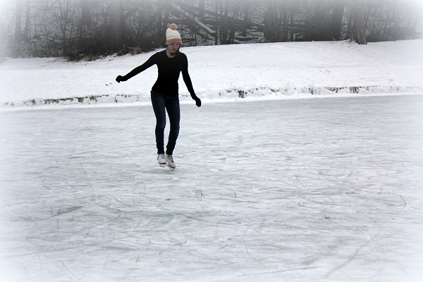 Mallory skating on Woodland Pond, Kalispell, Montana - RMKK Companion